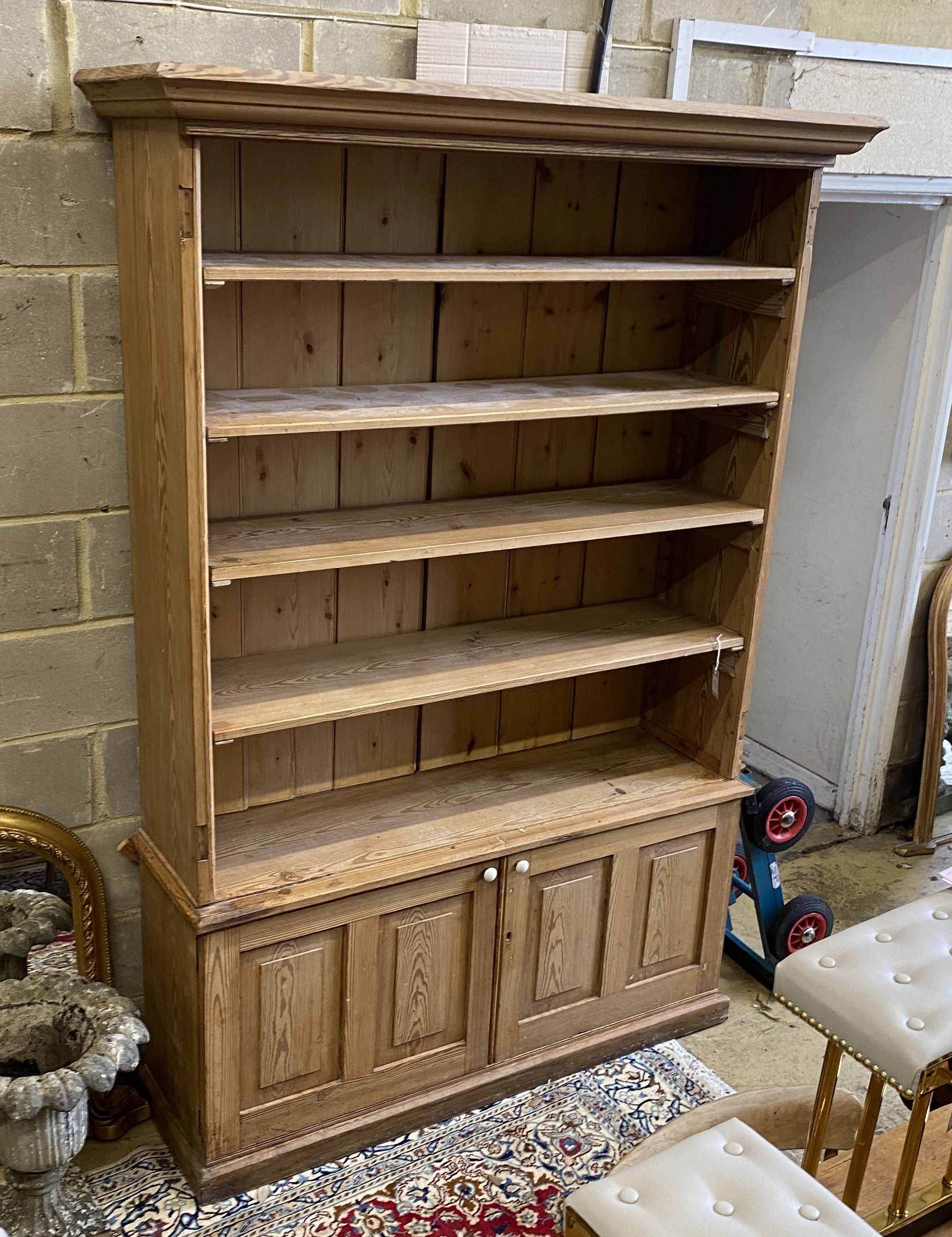 A Victorian stripped pine open fronted bookcase cupboard, length 150cm, depth 42cm, height 214cm